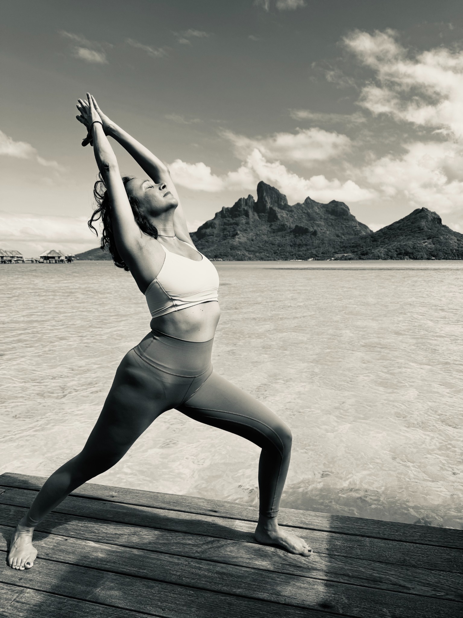 Anna practicing yoga by the water